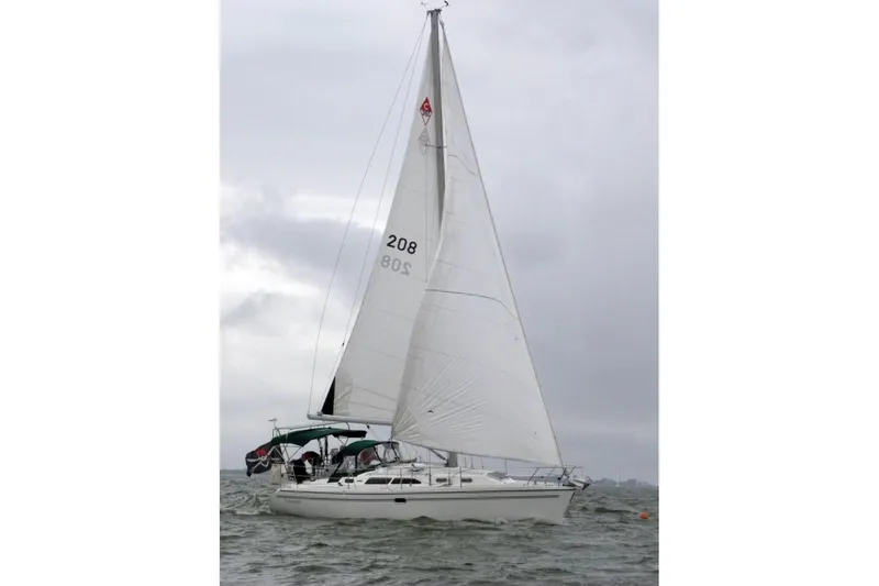 Slide: The Image of 2004 Catalina 350 sailboat navigating choppy waters under cloudy skies. - 7