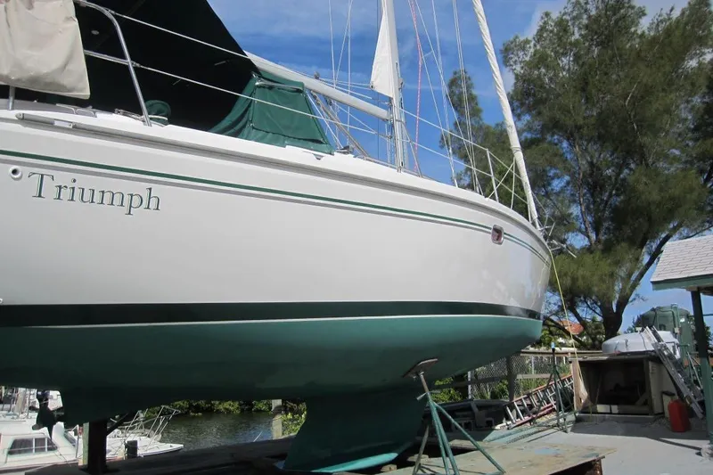 Slide: The Image of Catalina 350 sailboat named Triumph, 2004 model, docked with green accents. - 8