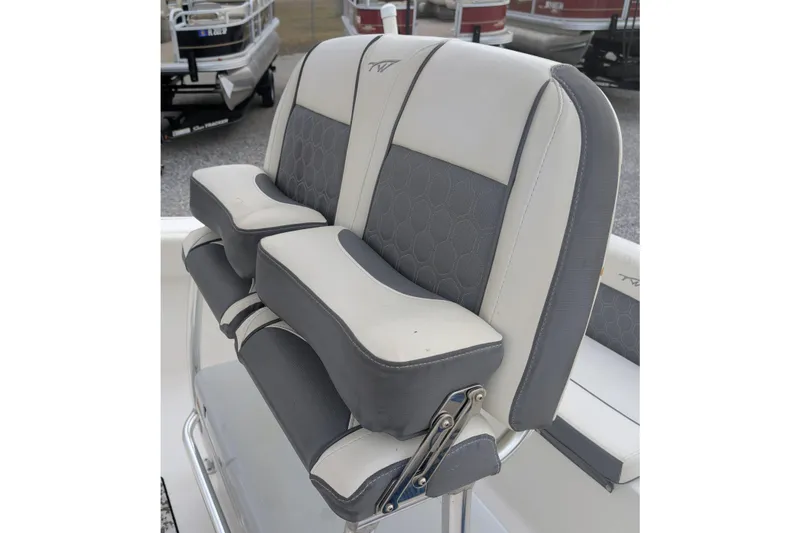 Slide: The Image of 2017 Tidewater 210 LXF boat seat with gray and white cushioned design. - 11