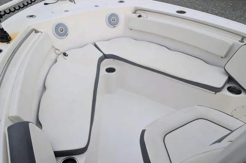 Slide: The Image of 2017 Tidewater 210 LXF boat interior with cushioned seating and cup holders. - 6