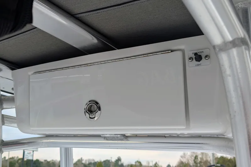 Slide: The Image of 2017 Tidewater 210 LXF boat console with storage compartment and light switch. - 7