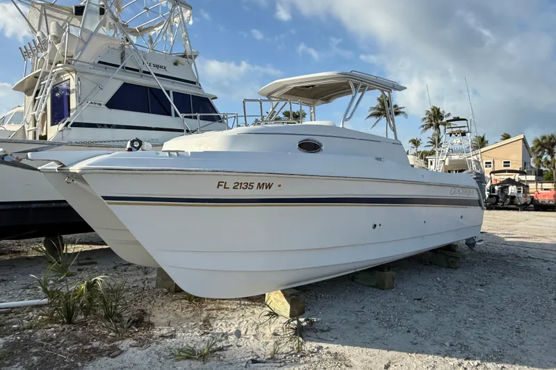 Slide: The Image of 2005 Glacier Bay 2680 Coastal Runner boat on dry dock, sunny day, palm trees in background. - 1