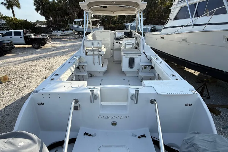 Slide: The Image of 2005 Glacier Bay 2680 Coastal Runner boat, spacious deck, parked outdoors. - 11