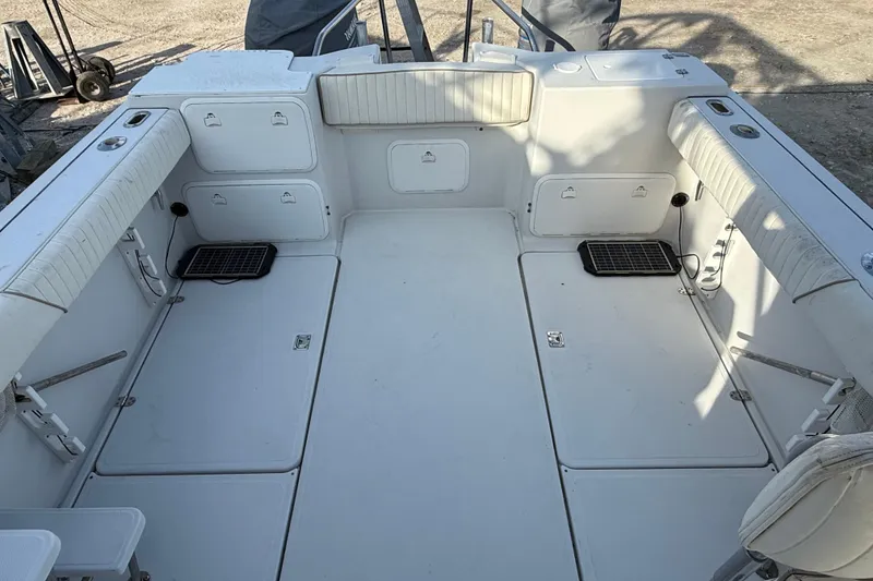 Slide: The Image of 2005 Glacier Bay 2680 Coastal Runner boat interior with spacious seating and storage compartments. - 17