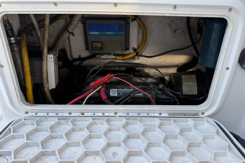 Slide: The Image of Battery compartment of 2005 Glacier Bay 2680 Coastal Runner with wiring and charger. - 22