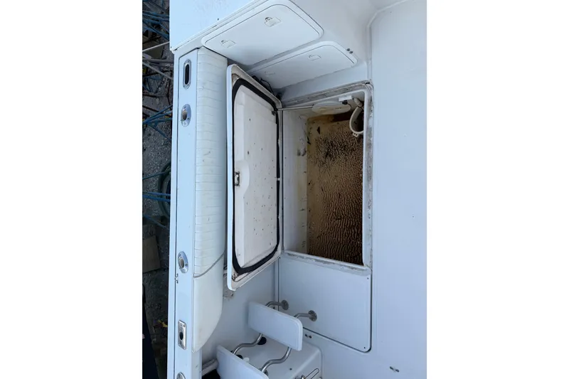 Slide: The Image of 2005 Glacier Bay 2680 Coastal Runner boat interior with open storage compartment. - 24