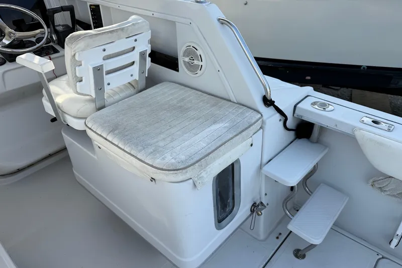 Slide: The Image of 2005 Glacier Bay 2680 Coastal Runner boat interior with seating and steering wheel. - 26