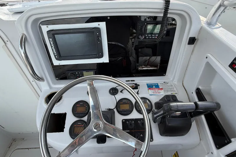 Slide: The Image of 2005 Glacier Bay 2680 Coastal Runner dashboard with steering wheel and navigation equipment. - 31