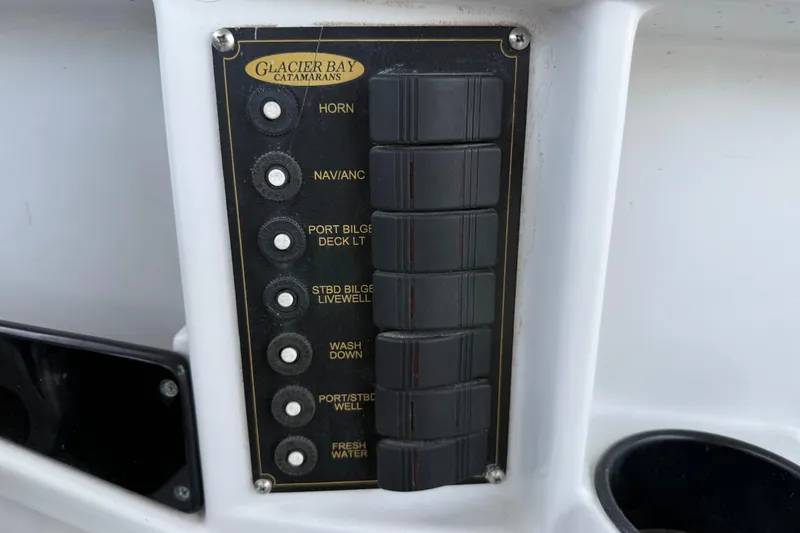Slide: The Image of Control panel of 2005 Glacier Bay 2680 Coastal Runner boat with labeled switches. - 38