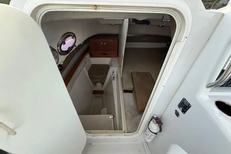 Slide: The Image of 2005 Glacier Bay 2680 Coastal Runner cabin interior with compact bathroom and storage. - 40
