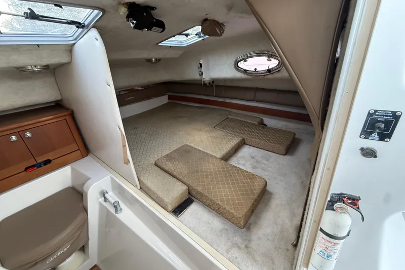 Slide: The Image of 2005 Glacier Bay 2680 Coastal Runner cabin interior with seating and storage. - 42