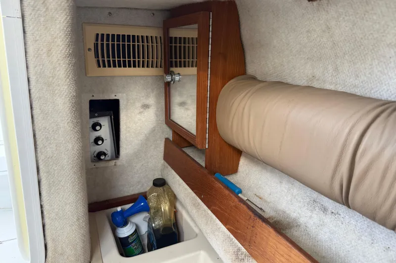 Slide: The Image of 2005 Glacier Bay 2680 Coastal Runner cabin interior with storage and control panel. - 43