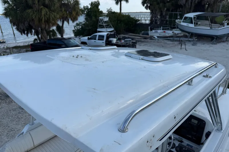 Slide: The Image of 2005 Glacier Bay 2680 Coastal Runner boat roof with hatch, parked near beach. - 47