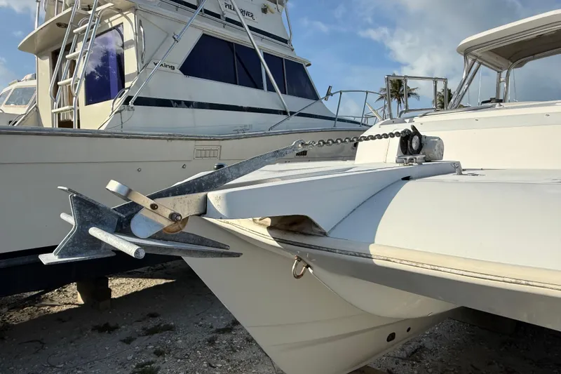 Slide: The Image of 2005 Glacier Bay 2680 Coastal Runner boat with anchor, docked under clear sky. - 6