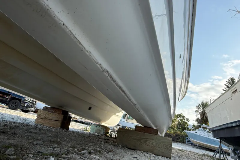 Slide: The Image of 2005 Glacier Bay 2680 Coastal Runner boat hull on blocks, outdoor storage. - 8