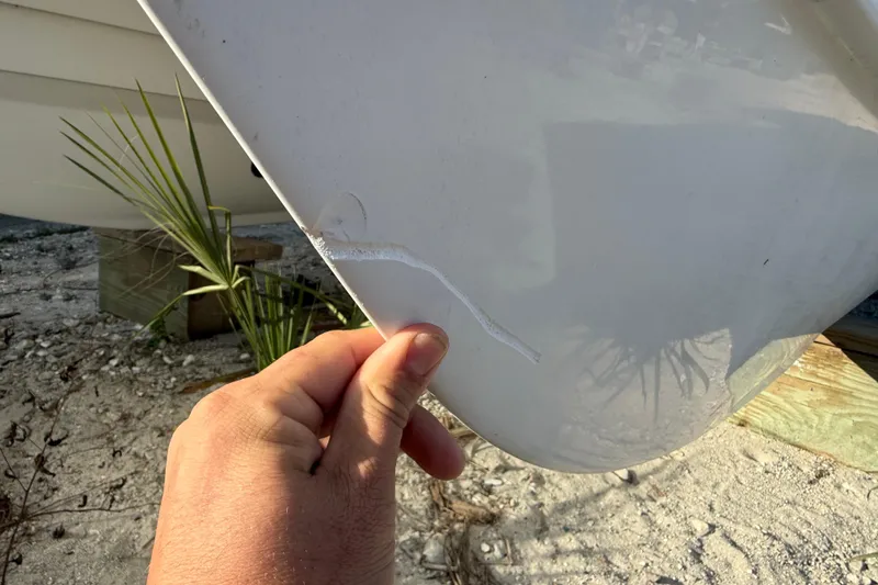 Slide: The Image of Close-up of a 2005 Glacier Bay 2680 Coastal Runner boat hull with visible damage. - 9