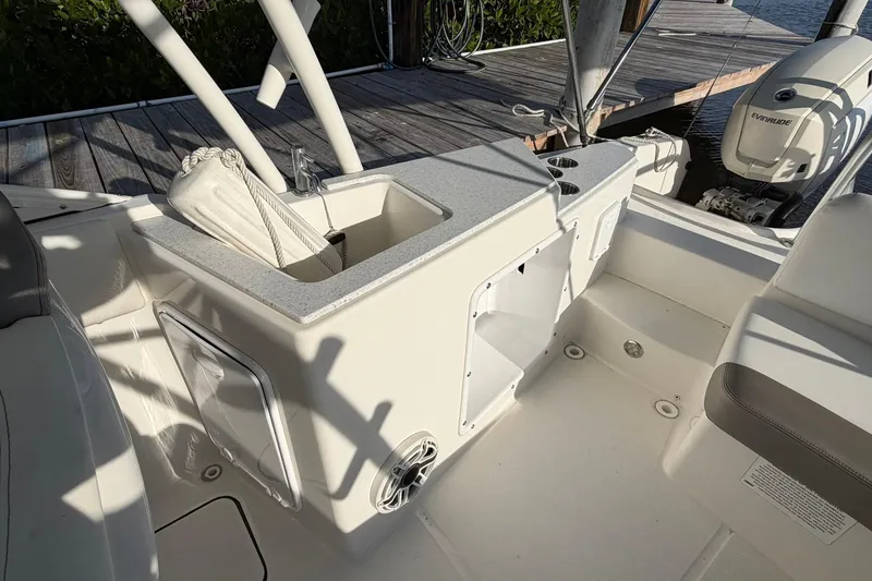 Slide: The Image of 2020 World Cat 230 SD boat interior with sink and storage compartments. - 10
