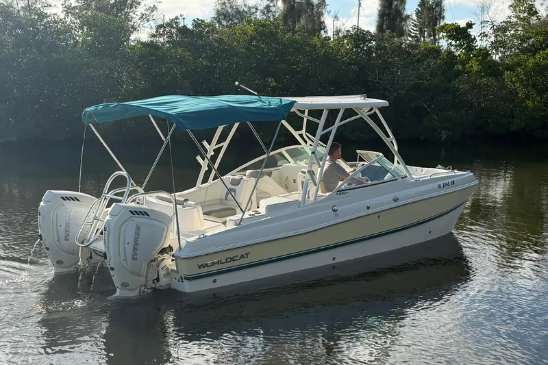 Slide: The Image of 2020 World Cat 230 SD boat with dual engines on a calm river. - 3