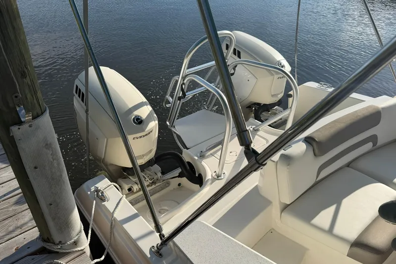 Slide: The Image of 2020 World Cat 230 SD boat with dual Evinrude engines docked by water. - 5