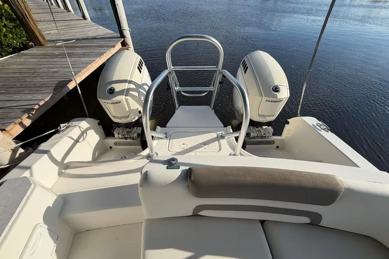 Slide: The Image of 2020 World Cat 230 SD boat with dual Evinrude engines docked by the water. - 7