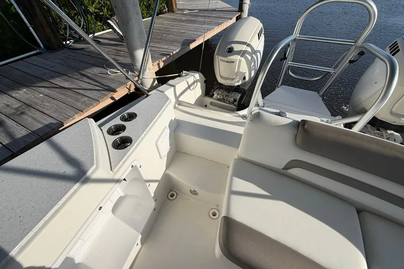 Slide: The Image of 2020 World Cat 230 SD boat interior with seating and Evinrude outboard motor. - 8