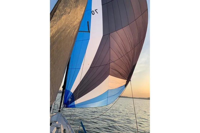 Slide: The Image of Sailing on a 2006 J Boats J/100 with colorful spinnaker at sunset. - 10