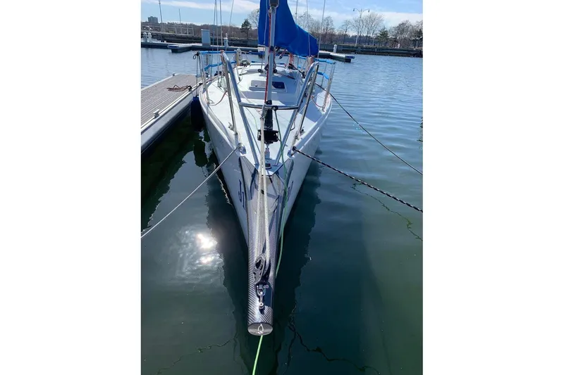 Slide: The Image of 2006 J Boats J/100 sailboat docked in calm marina waters. - 11