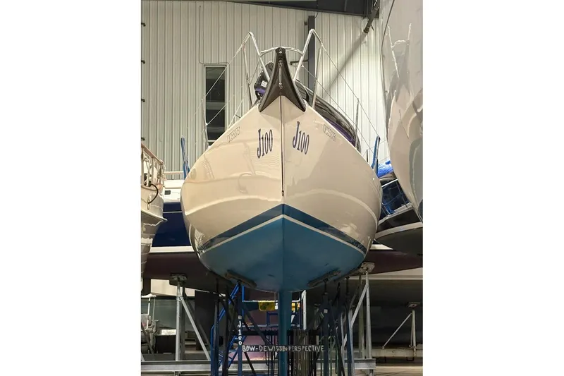 Slide: The Image of 2006 J Boats J/100 sailboat in storage, viewed from the bow. - 15