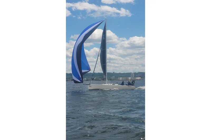 Slide: The Image of 2006 J Boats J/100 sailing with blue spinnaker on a sunny day. - 2