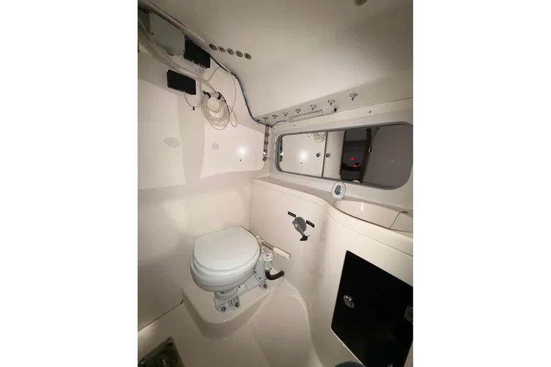 Slide: The Image of Interior of 2006 J Boats J/100 sailboat, featuring a compact marine toilet setup. - 24