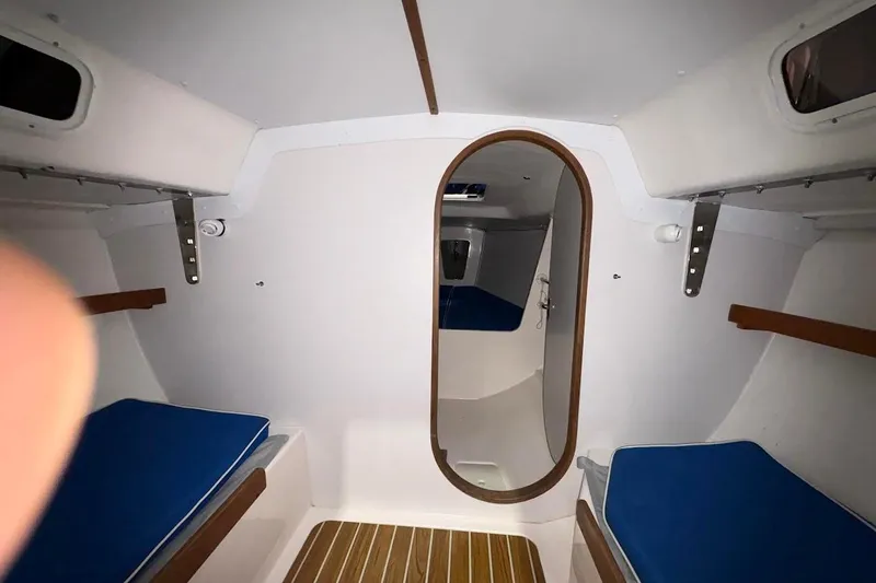 Slide: The Image of Interior cabin of 2006 J Boats J/100 sailboat with blue cushions and wooden accents. - 27