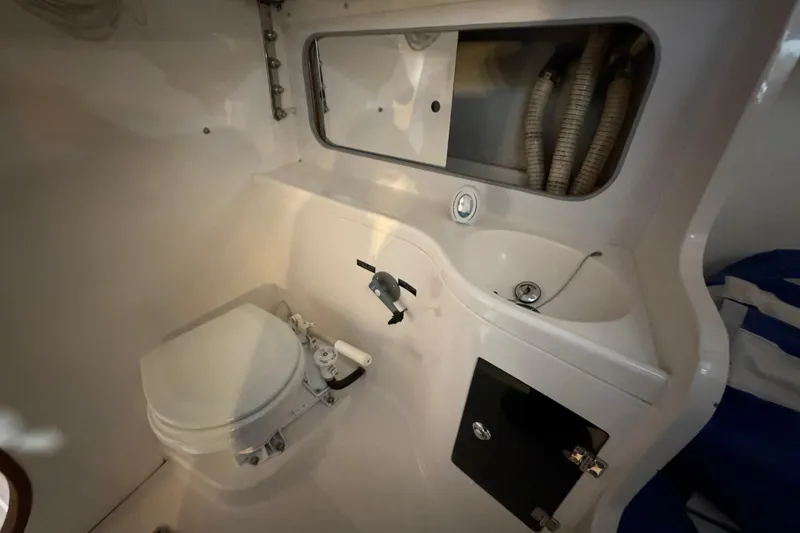 Slide: The Image of 2006 J Boats J/100 yacht bathroom with toilet, sink, and storage cabinet. - 32