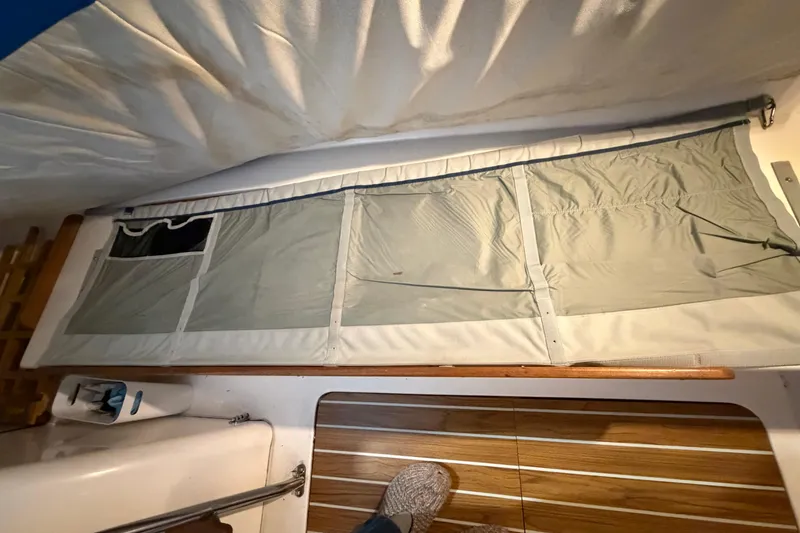 Slide: The Image of Interior view of 2006 J Boats J/100 sailboat with storage pockets and wooden flooring. - 39