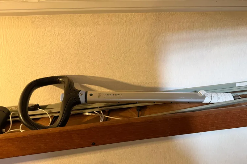 Slide: The Image of Steering wheel of a 2006 J Boats J/100 sailboat, mounted on a wooden shelf. - 48