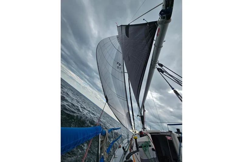 Slide: The Image of Sailing on a 2006 J Boats J/100 under cloudy skies, showcasing sleek design and performance. - 9