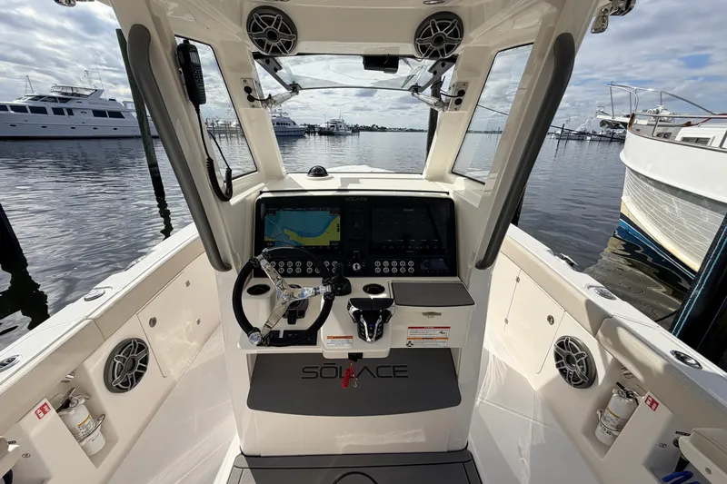 Slide: The Image of Cockpit of 2026 Solace 30 CS boat with advanced navigation system and steering wheel. - 13