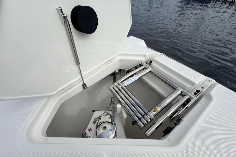 Slide: The Image of Open hatch of 2026 Solace 30 CS boat with ladder and anchor storage. - 19