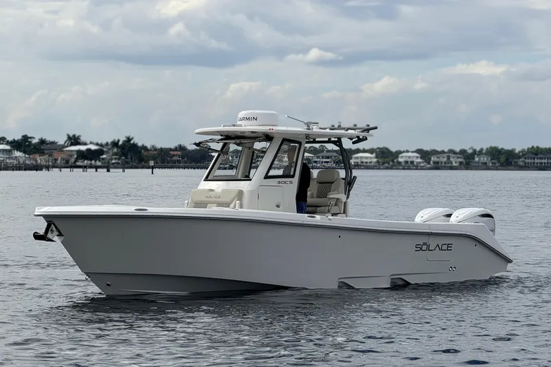 Slide: The Image of 2026 Solace 30 CS boat on calm water, showcasing sleek design and modern features. - 4