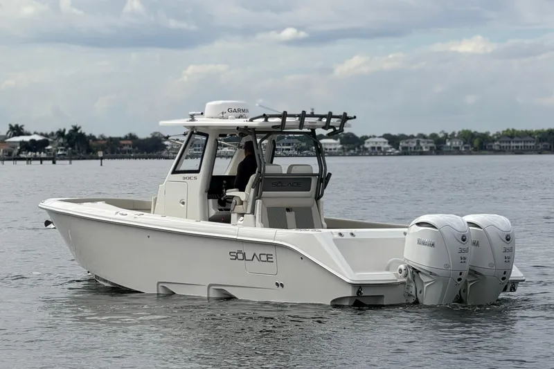 Slide: The Image of 2026 Solace 30 CS boat with twin Yamaha engines on calm water. - 6