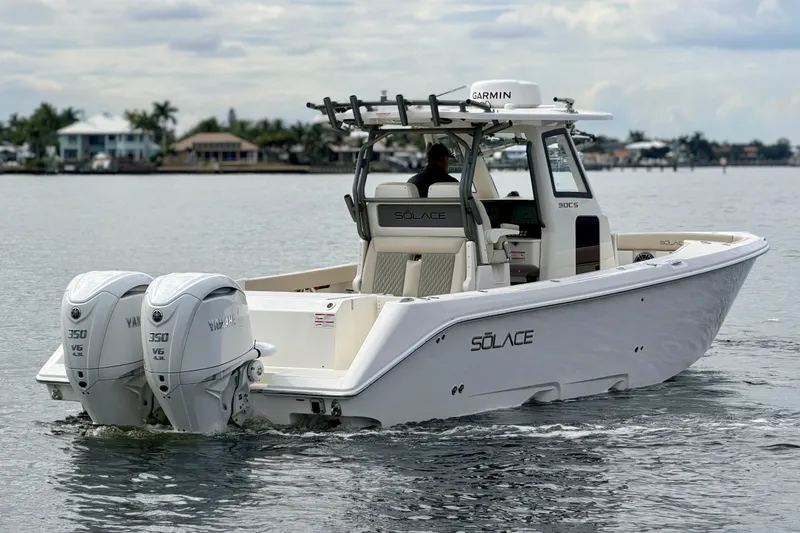 Slide: The Image of 2026 Solace 30 CS boat with twin Yamaha 350 engines on calm water. - 9