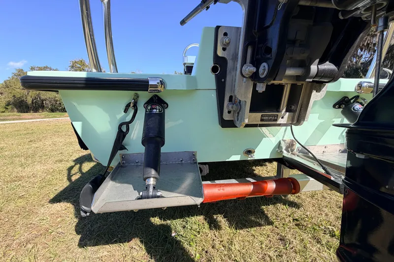 Slide: The Image of 2011 Hell's Bay Glades Skiff boat rear view, showcasing motor mount and trim tabs. - 16