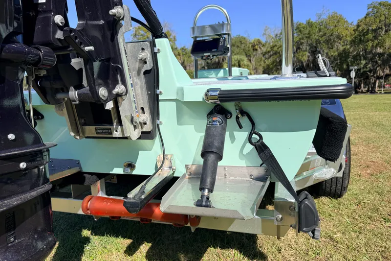 Slide: The Image of 2011 Hell's Bay Glades Skiff boat rear view with motor and trim tab details. - 17