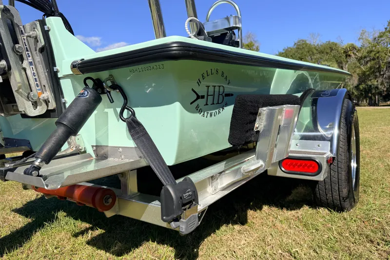 Slide: The Image of 2011 Hell's Bay Glades Skiff on trailer, showcasing boat details and logo. - 18