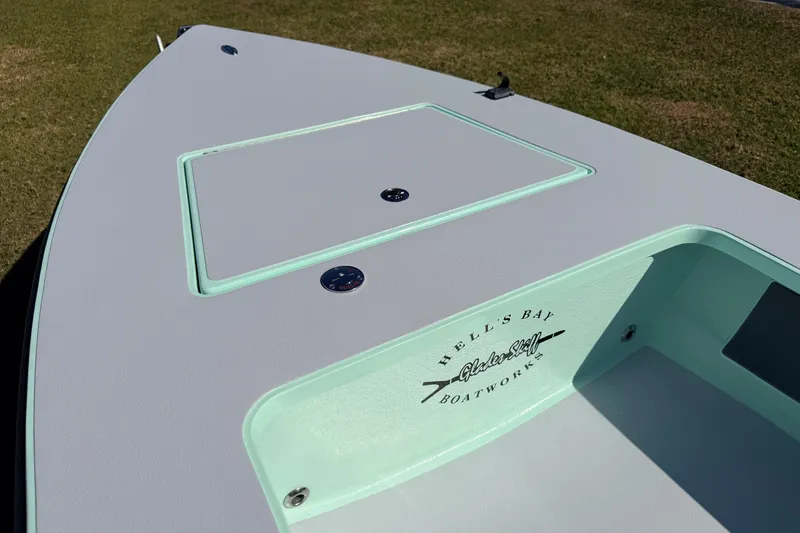 Slide: The Image of 2011 Hell's Bay Glades Skiff boat deck with logo, showcasing sleek design. - 20