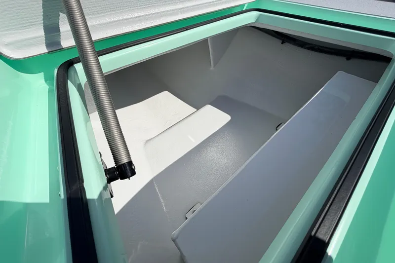 Slide: The Image of 2011 Hell's Bay Glades Skiff storage compartment with open lid and hydraulic support. - 23