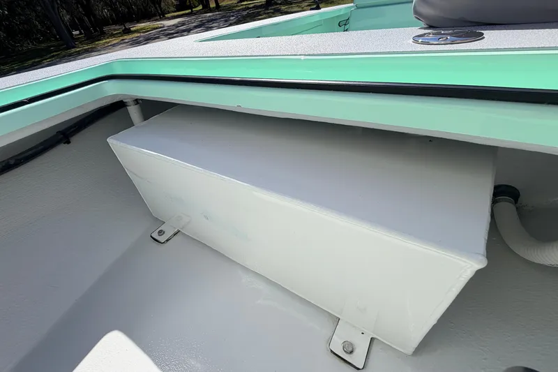 Slide: The Image of 2011 Hell's Bay Glades Skiff interior detail with storage compartment and mint green trim. - 24