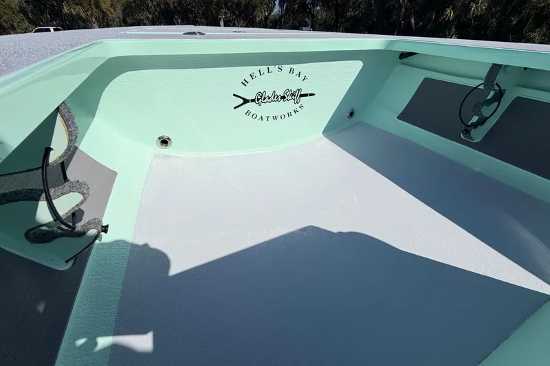 Slide: The Image of 2011 Hell's Bay Glades Skiff interior with logo, light green and gray color scheme. - 25