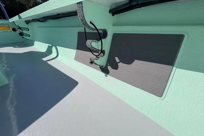 Slide: The Image of 2011 Hell's Bay Glades Skiff interior detail with mint green finish and storage features. - 26