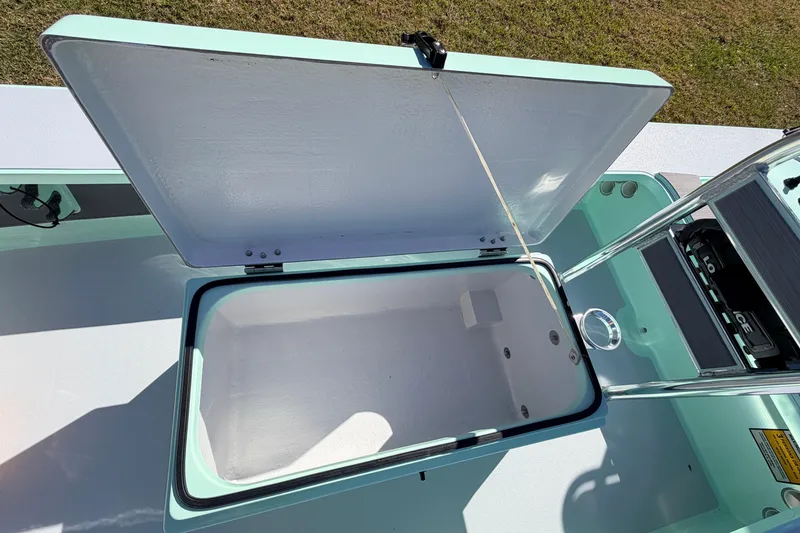 Slide: The Image of Open storage compartment on a 2011 Hell's Bay Glades Skiff boat, showing interior details. - 31