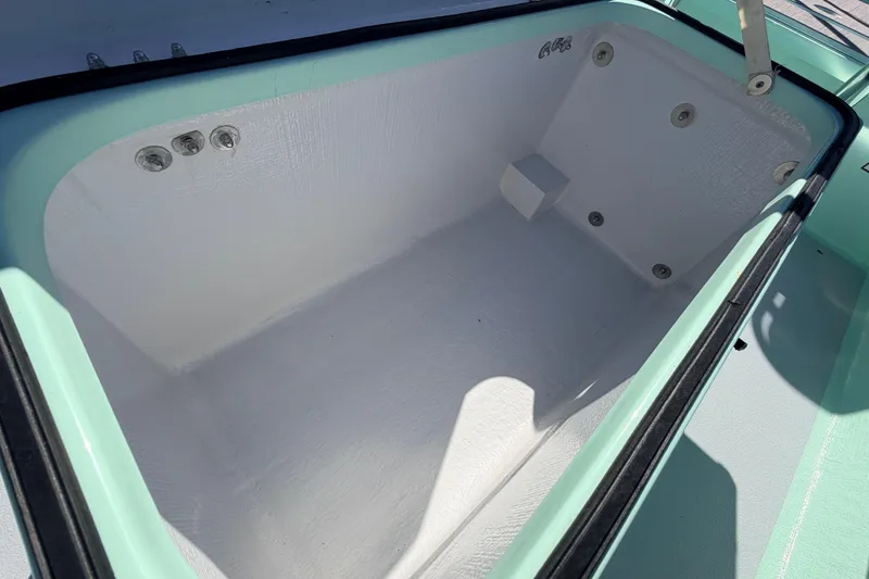 Slide: The Image of 2011 Hell's Bay Glades Skiff interior compartment, featuring a clean, white finish. - 32